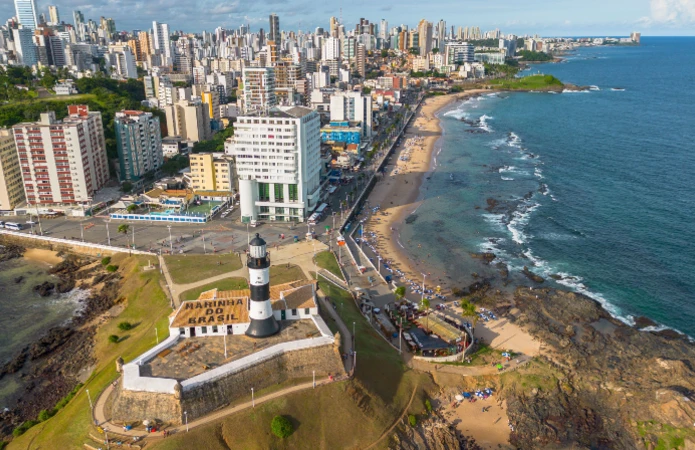 The lighthouse stands within the historic Forte de Santo Antônio da Barra and has watched over the coast for centuries.