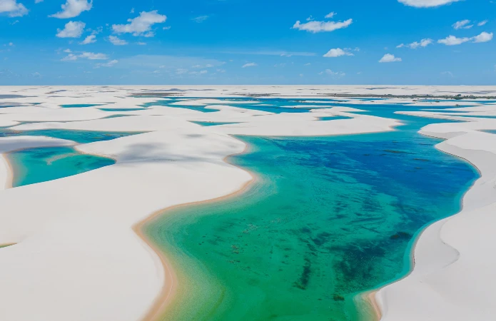 Located on the coast of Maranhão, Lençóis Maranhenses is famous for its vast fields of white sand dunes and freshwater lagoons.