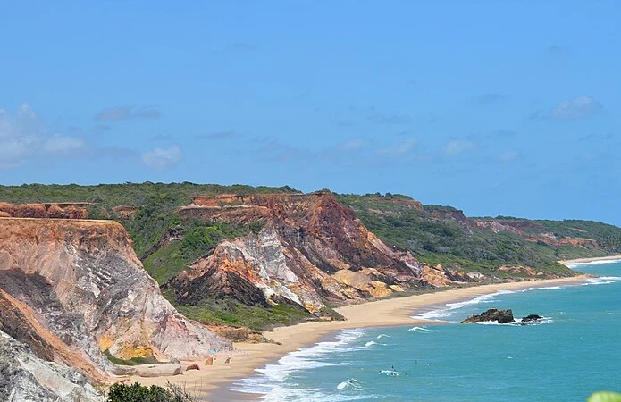 Colorful cliffs, coconut groves, and clear Atlantic waters define Praia de Coqueirinho